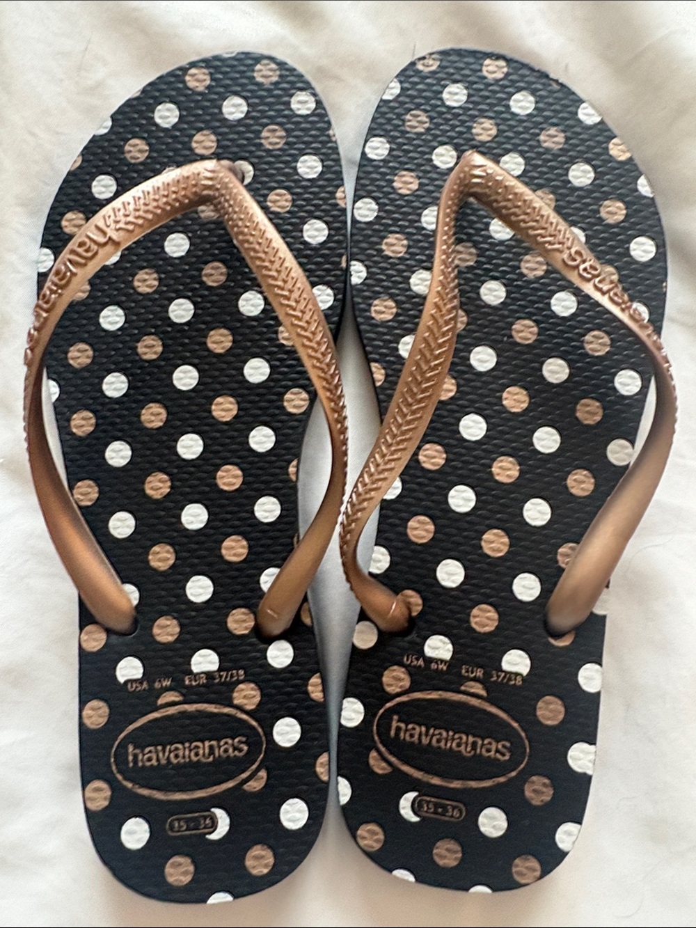 Havaianas Black Flip Flops with Gold Straps and Accents